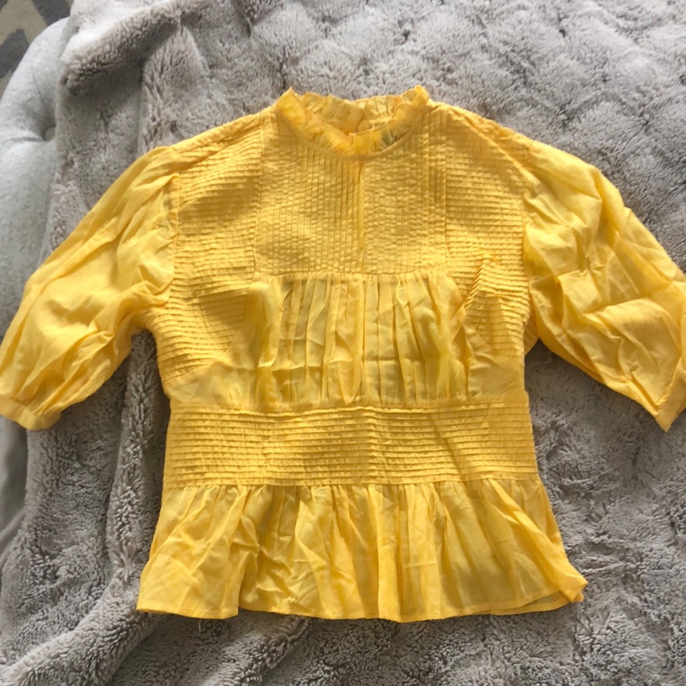 Beautiful, delicate peplum blouse with great details, buttons down the back